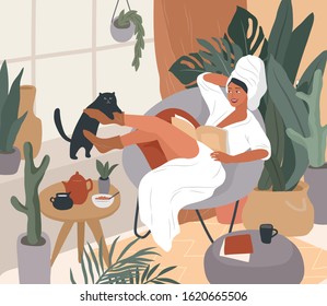 Happy cute girl with towel on head and in bathrobe, having breakfast in morning after bathing, read the newspaper and resting with cat. Feminine Daily life by young woman in interior with homeplant