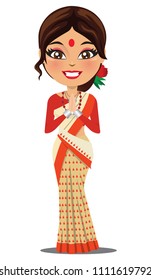 A happy and cute Indian woman wearing a traditional saree from the state of Assam in North East India in a namaste pose