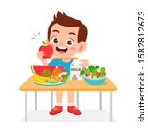 happy cute kid boy eat healthy food