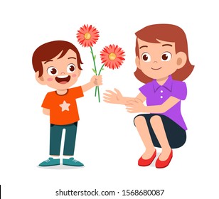 happy cute kid boy gives flower to mother