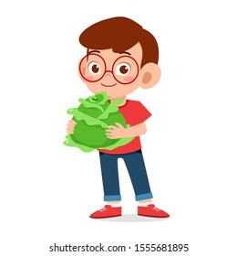 happy cute kid boy holding fresh vegetable