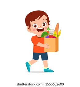 happy cute kid boy holding fresh groceries