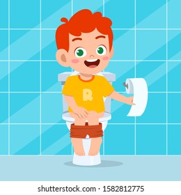 happy cute kid boy sit on the toilet
