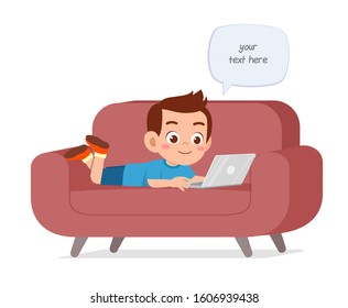 happy cute kid boy use laptop on sofa