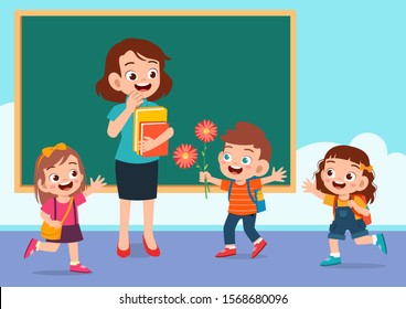 happy cute kid gives flower to teacher