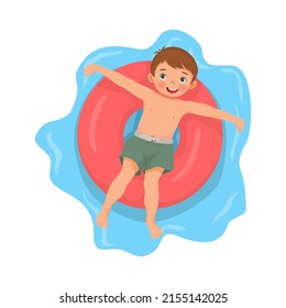 happy cute little boy with swimsuit lying on inflatable rubber ring having fun floating in swimming pool on summer time