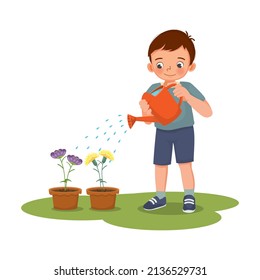 Happy cute little boy watering plants flowers in the pot with watering can in the garden