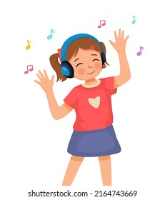 Happy cute little girl dancing while listening to music with headphone 