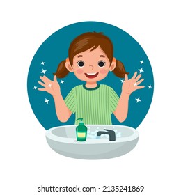 Happy cute little girl showing her clean hands after washing hands with antibacterial soap and water at the sink and as prevention against Virus and Infection and personal hygiene