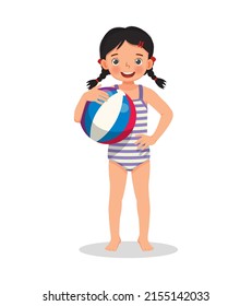 happy cute little girl with swimsuit holding inflatable beach ball with hand on waist pose having fun on summer time