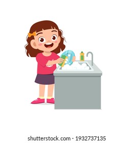 happy cute little girl washing dish in the kitchen