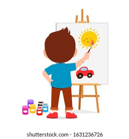 happy cute little kid boy draw on canvas