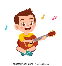 happy cute little kid boy play guitar