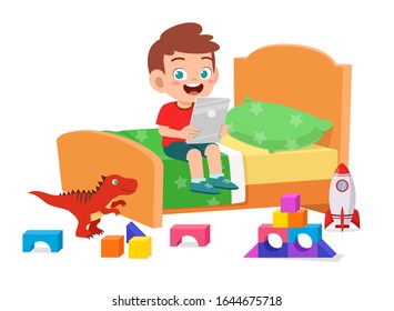 Happy Cute Little Kid Boy Play With Tablet In Bed Room