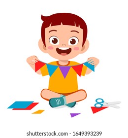 happy cute little kid boy make paper craft