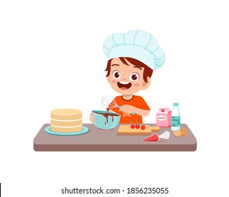 happy cute little kid boy and girl wear chef uniform and cooking a birthday cake