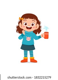 happy cute little kid drink hot chocolate in winter season. child drink milk wearing warm clothes