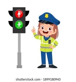 happy cute little kid girl wearing police uniform and stand beside traffic lamp