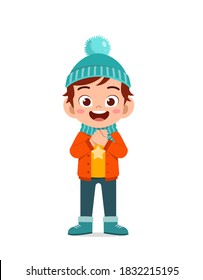 happy cute little kid play and wear jacket in winter season. child smile wearing warm clothes