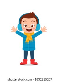 happy cute little kid play and wear jacket in winter season. child smile wearing warm clothes