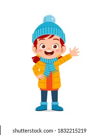 happy cute little kid play and wear jacket in winter season. child smile wearing warm clothes