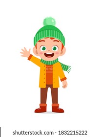 happy cute little kid play and wear jacket in winter season. child smile wearing warm clothes