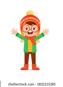 happy cute little kid play and wear jacket in winter season. child smile wearing warm clothes