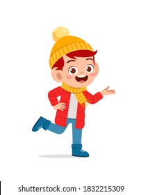 happy cute little kid play and wear jacket in winter season. child smile wearing warm clothes