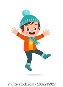 happy cute little kid play and wear jacket in winter season. child smile wearing warm clothes