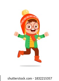 happy cute little kid play and wear jacket in winter season. child smile wearing warm clothes