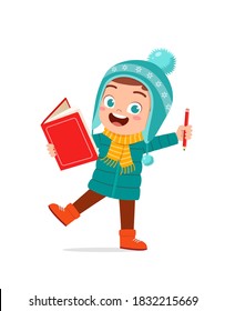 happy cute little kid study and wear jacket in winter season. child read book wearing warm clothes