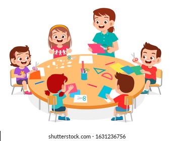 happy cute little kids boy and girl make paper craft with teacher