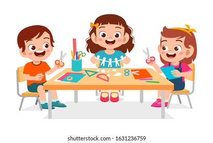 happy cute little kids boy and girl make paper craft