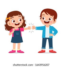 happy cute little kids boy and girl fist bump