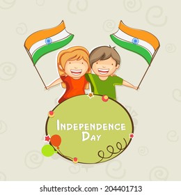 Happy cute little kids holding Indian National Flags in their hands on abstract grey background for 15th of August, Independence Day celebrations. 