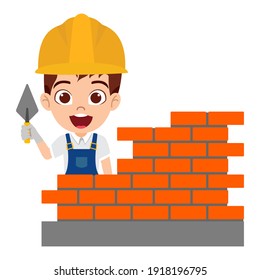 Feliz lindo muchacho lindo e inteligente que usa ropa de obrero de construcción con alegre expresión construyendo pared de ladrillos