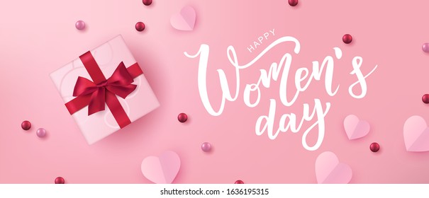 Happy Woman’s Day hand lettering text with realistic looking gift with bows and hearts. Vector illustration. 8 March greeting calligraphy design. Template for a poster, cards, banner.