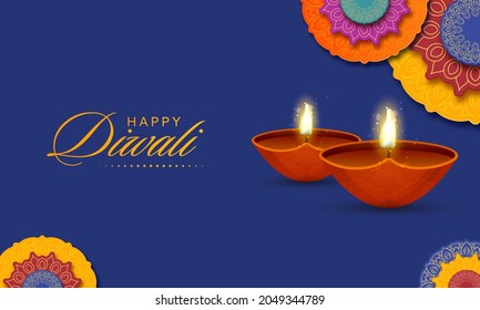 Happy Diwali Celebration Concept With Realistic Lit Oil Lamps (Diya) And Overlay Paper Mandala Pattern On Blue Background.