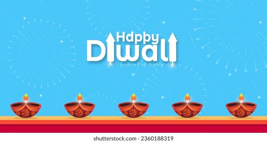 Happy Diwali festival of lights background. Firecrackers bursting in blue sky with diya lined up on red brick wall in Happy Diwali festival.