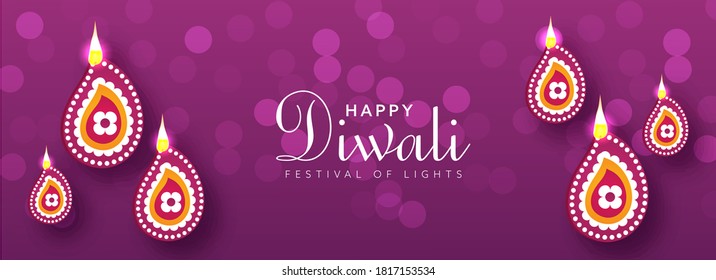 Happy Diwali Festival Of Lights Text on Purple Bokeh Blur Background Decorated with Top View Lit Oil Lamps (Diya).