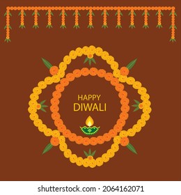  Happy Diwali with yellow and orange marigold floral and green mango leaves decoration with earhen lamp on brown color background