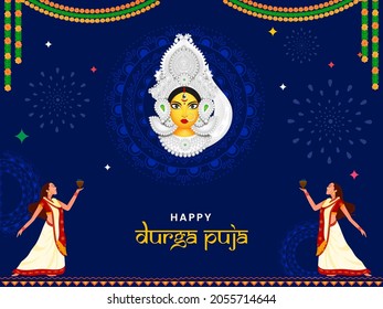 Happy Durga Puja Concept With Goddess Durga Face And Bengali Women Performing Dhunachi Dance On Blue Mandala Pattern Background.
