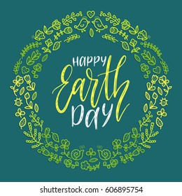 Happy Earth Day hand lettering in round floral frame on blue background. Vector global holiday illustration for greeting card, poster etc.