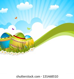 Happy Easter background or card with decorated eggs in grass on nature background.