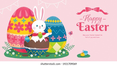 Happy Easter banner with cute rabbit sitting in beautiful chocolate eggs on green grass. Concept of egg hunt.