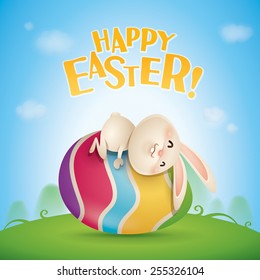 Happy Easter! Easter bunnies and egg in field. Wide copy space for text.