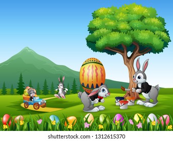 Happy easter bunnies painting and holding egg