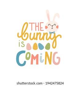Happy Easter The bunny is coming label. greeting logo. Traditional symbolic elements for celebrating spring holiday. Bright card with easter bunny, painted eggs and spring flowers.