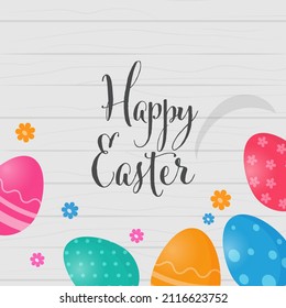 Happy Easter Calligraphy With Colorful Printed Eggs, Flowers Decorated On Gray Wooden Background.