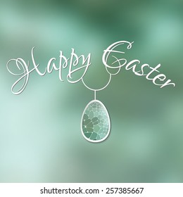 Happy Easter card with 3d geometric egg on green blurred background.
